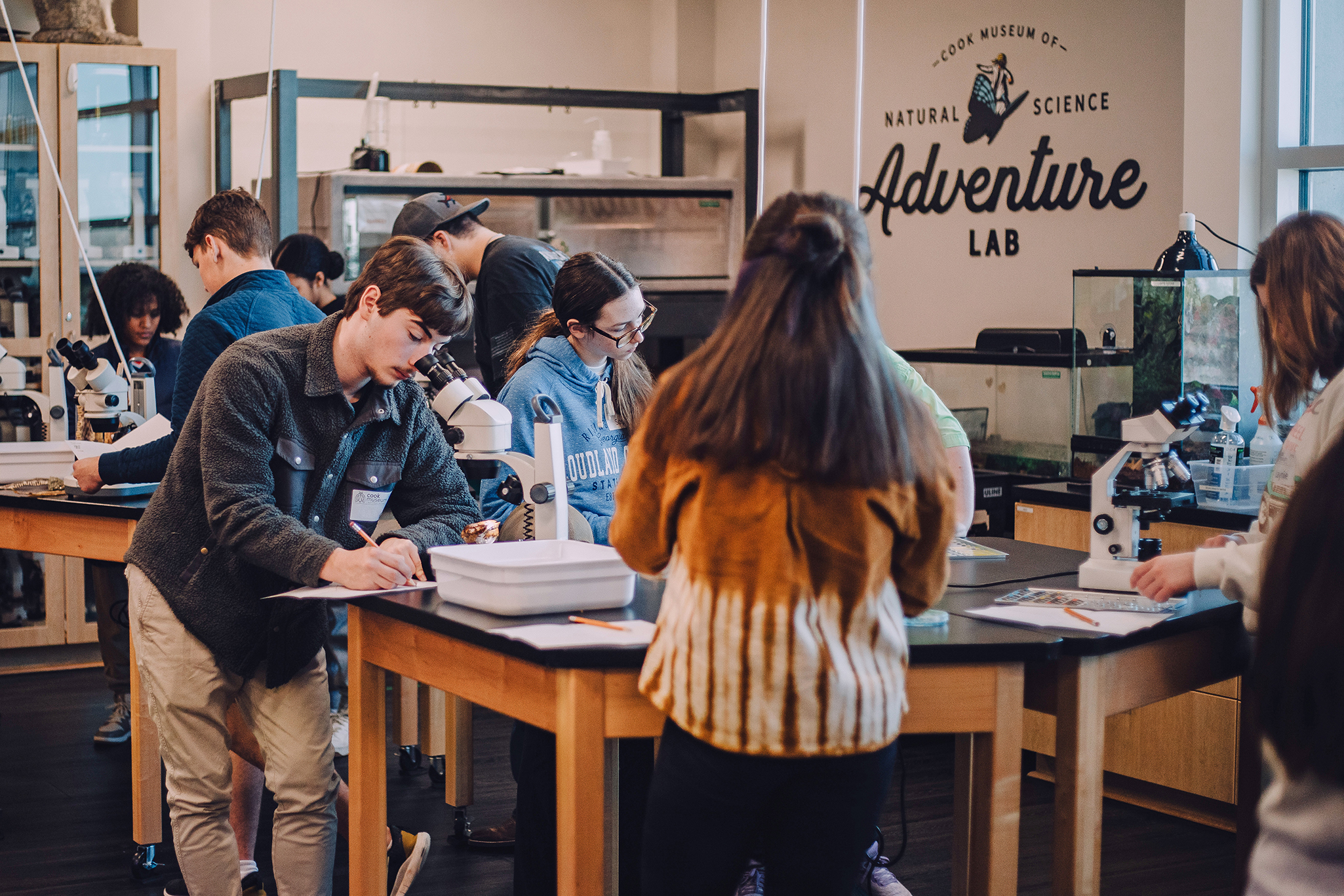 Young students looking at snake